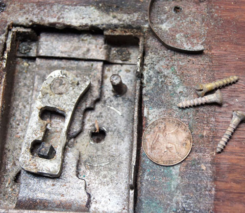 A coin found behind the lock plate of the Water Torture Cell.